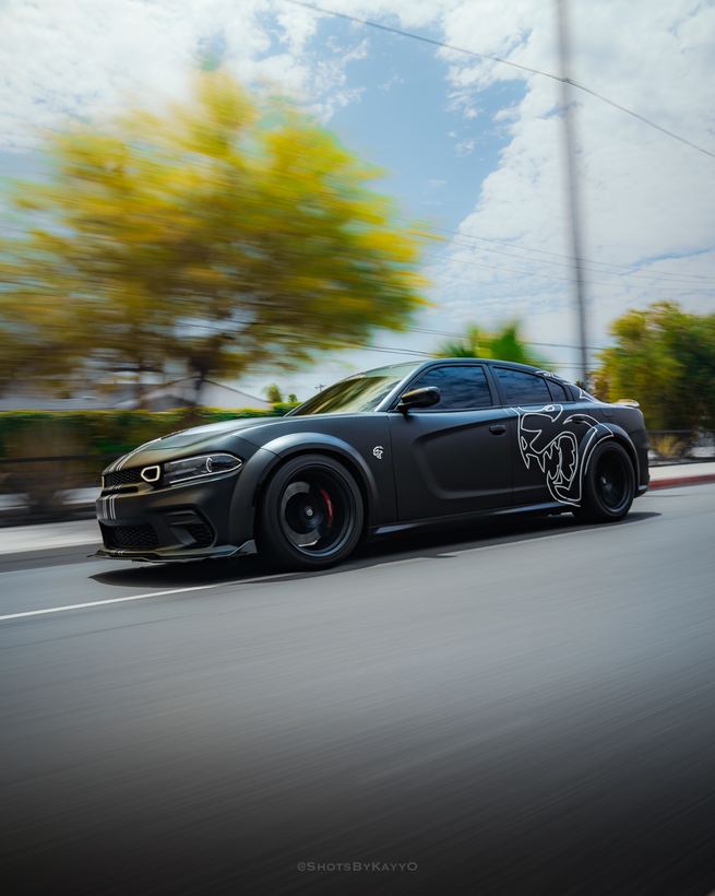 Black widebody Dodge Hellcat rolling shot